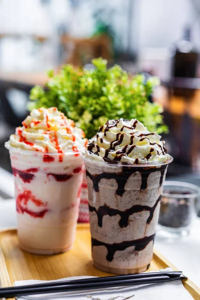 chocolate and strawberry frappe with whipped cream on table