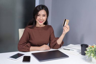 online alışveriş için kredi kartı kullanan mutlu kadın