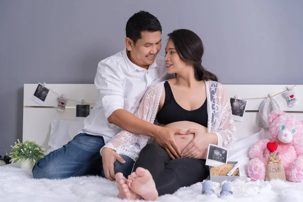 Marido Sua Esposa Grávida Mostrando Coração Com Mãos Cama — Fotografia de Stock