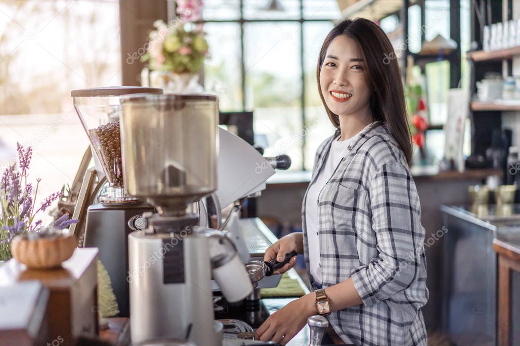 woman preparing coffee with machine in a cafe