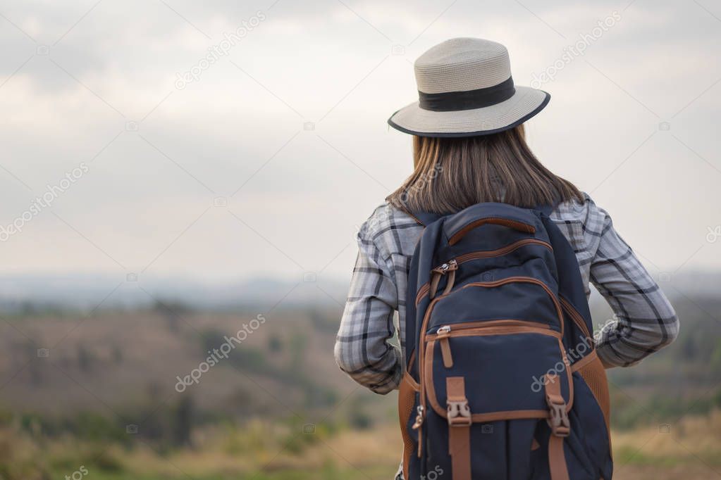 female tourist with backpack in the countryside