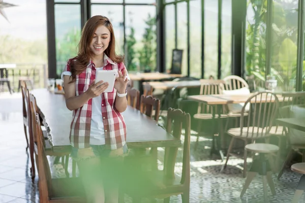 stock image happy woman using digital tablet in cafe