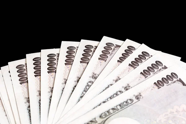 Billete japonés sobre fondo negro, Yen es moneda oficial — Foto de Stock