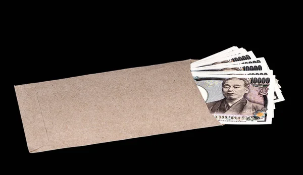 Japan money inside paper envelope on black background — Stock Photo, Image