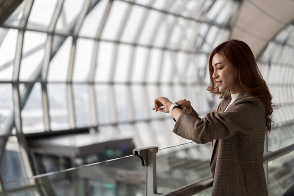 Γυναίκα περιμένει την πτήση και αναζητούν έξυπνο ρολόι στο αεροδρόμιο — Φωτογραφία Αρχείου