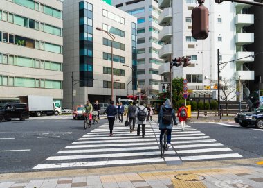 Unidendified insanlar Tokyo city, Japonya'da caddenin karşısında yürümek