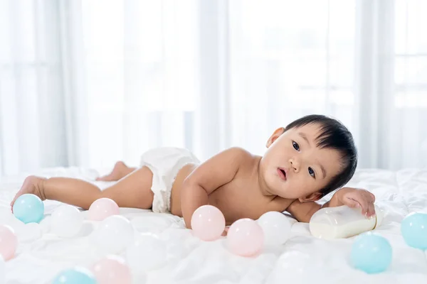Cheerful baby lying on bed — Stock Photo, Image