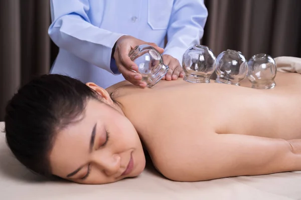 Woman receiving cupping treatment on back — Stock Photo, Image