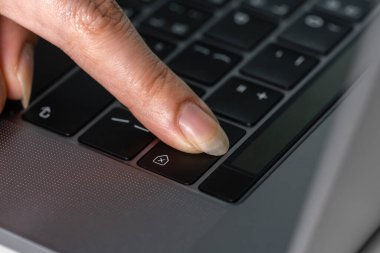 close-up female hand pressing a Backspace key for delete on a laptop keyboard clipart