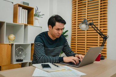 stressed young man working with laptop computer at home office