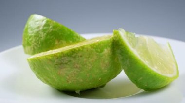 Taze yeşil limon dilimi yavaşça ayrıntıları ile stüdyoda döndürme.