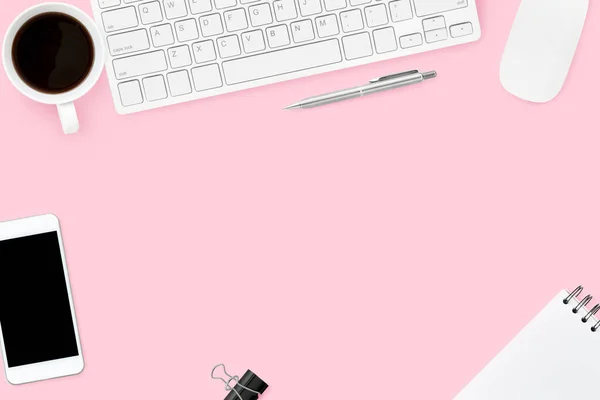 Pink pastel woman office desk with computer gadgets, coffee, smartphone and supplies. Top view with copy space, flat lay.