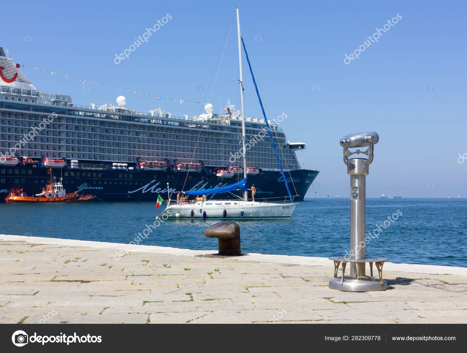Sailboat In Front Of A Cruise Ship In Trieste Stock