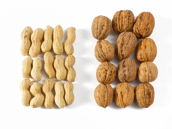 Set Fifteen Peanuts Next Set Twelve Walnuts White Background — Stock Photo, Image