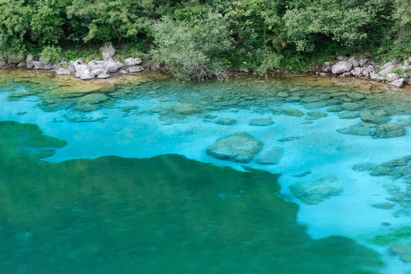 The peculiar turquoise color of the waters of the small Cornino lake in Friuli region, Italy, inside the natural reserve of the same name