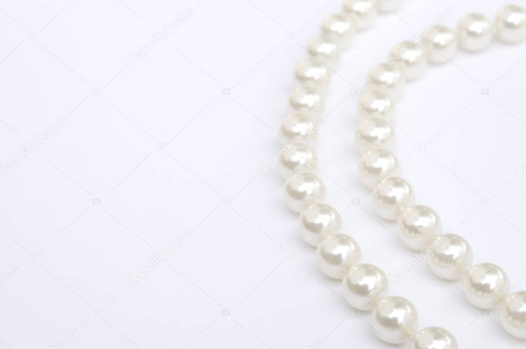 Pearls isolated on white. High key image. Very shallow depth of field.