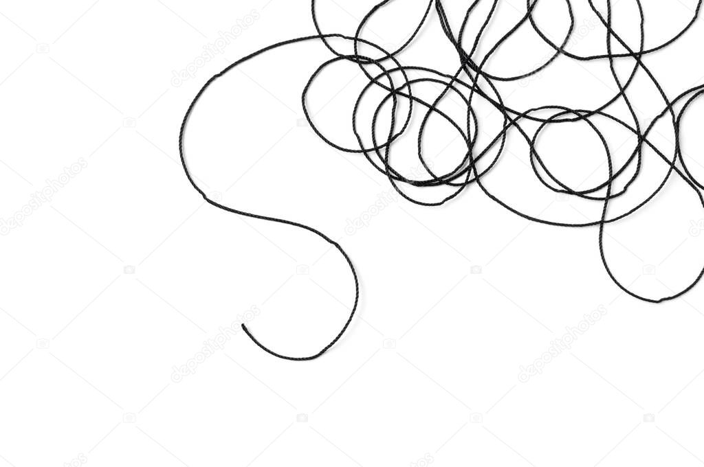Tangled black thread on white background.