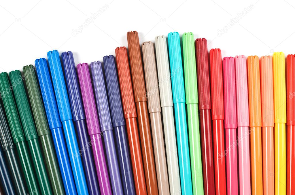 Colored felt tip pens in a row on white background.
