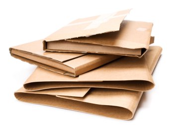 Stack of cardboard book mailers on white background. clipart
