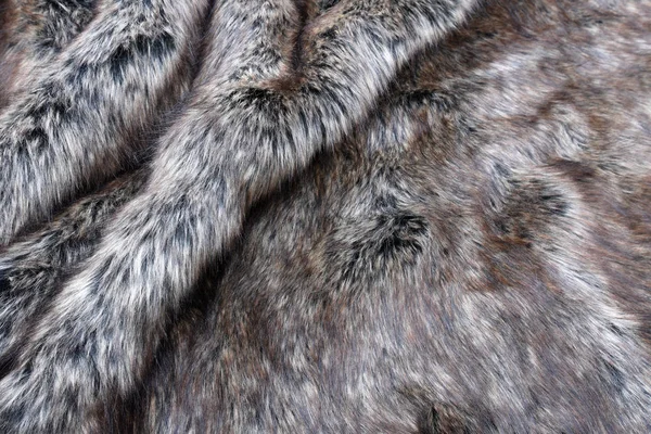 オオカミ偽の毛皮のテクスチャの背景 — ストック写真