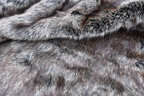 オオカミ偽の毛皮のテクスチャの背景 — ストック写真