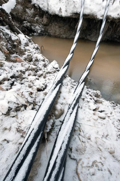 Laying a fiber optic and electricity cables in the frozen ground — Stock Image Laying a fiber optic and electricity cables in the frozen ground Stock Image