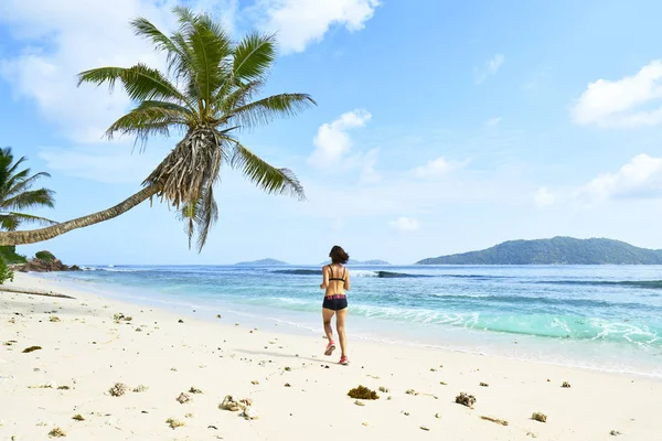 Running woman. Female runner jogging during outdoor workout on b 로열티 프리 스톡 사진