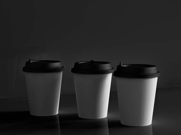 3d model of paper cups on the plane under natural light. Black b