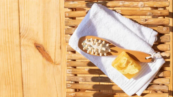 Set for a steam bath. Towel, soap and body brush. View from above. Bright sunshine and shadows. — Stock Photo, Image