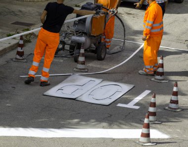 Yol inşaatındaki makine ve işçiler yol ve trafik işaretleri boyası için kullanılıyor