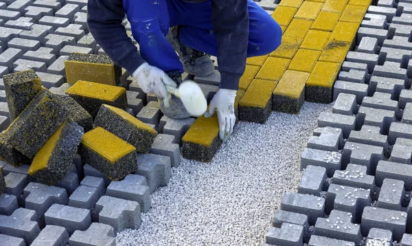 Robotnik Budowlany Układa Blokady Betonu Nawierzchniowego Blachę Włókniny Piasku Pościelowego — Zdjęcie stockowe