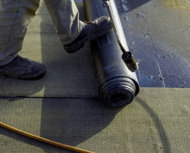 Gaz kalorifer meşale alev tarafından erime için keçe rulo çatı asfalt parçası hazırlama işçisi. Kılıf arkasında damgası 