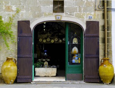 Grottaglie, Italy - August 17, 2018: Entrance to a ceramic workshop. The city in province of Taranto, Apulia region, southern Italy, famous for artistic ceramics. clipart