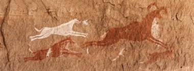 Prehistoric Petroglyphs in libian sahara desert clipart