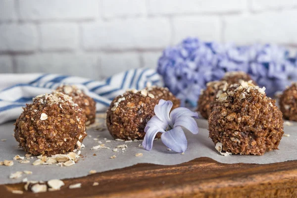 Healthy organic energy granola balls with oat flakes, peanuts, dates, cacao, banana, chocolate and honey - vegan vegetarian raw snack or meal