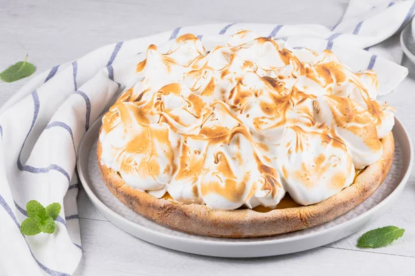 Lemon tart pie with meringue cream. Traditional American cake. Homemade baking. Copy space.