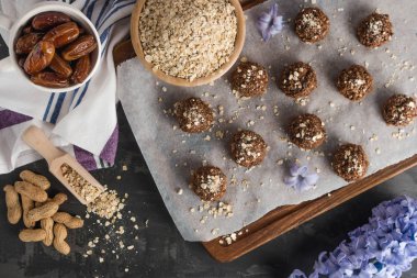 Yulaf ezmesi, fıstık, hurma, kakao, muz, çikolata ve bal içeren sağlıklı organik enerji granola topları - vejetaryen çiğ çerez veya yemek