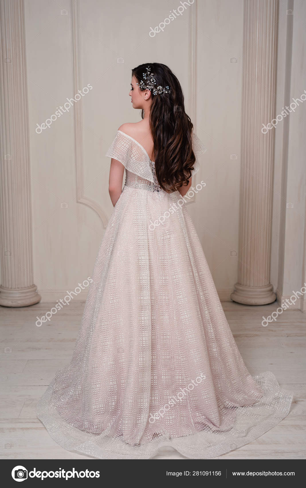 Healthy long hair. Beautiful brunette bride girl with long Wavy hairstyle  and professional makeup. Indoor portrait. Stock Photo by  ©@ 281091156