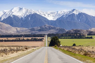 Long Straight Road and Mountains in Arthurs Pass, New Zealand clipart