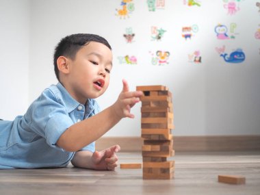 Tahta bloklar ile yere oynayan küçük çocuk