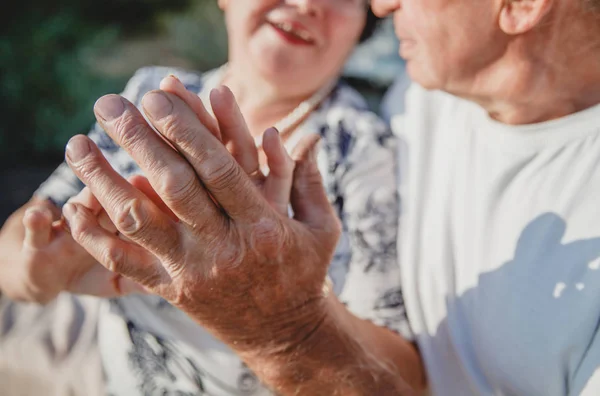 hands of an old couple in love