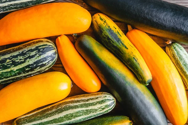 Randomly laid out different-grade multicolored zucchini. The view from the top