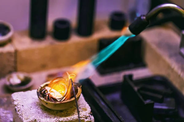 Initial stage of melting precious metals in a jewelry workshop,