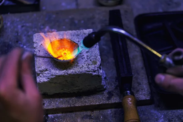 Jeweler melts gold in a crucible. Workshop workflow