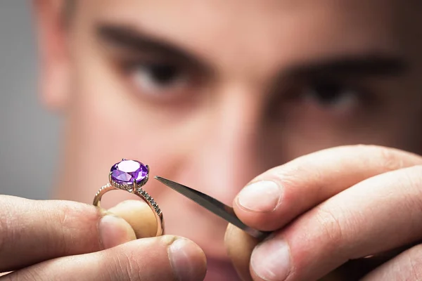 Master will examine the jewelry for defects. Close-up workflow