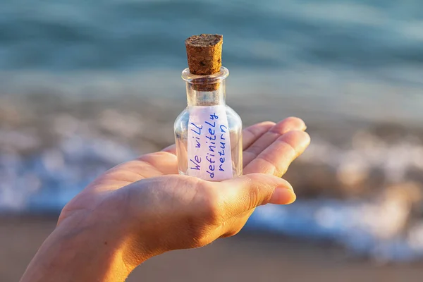 Message in a bottle with the inscription: we will definitely ret