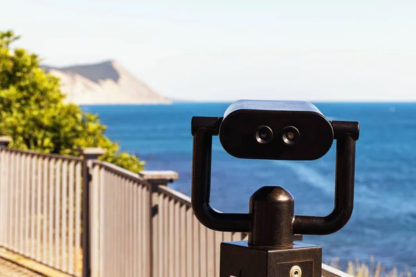 Tourist binoculars on the observation deck near the sea