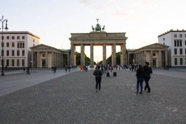 Berlin, Almanya - 29 Mayıs 2019: Gün batımında Berlin Brandenburg Kapısı (Brandenburger Tor) yakınındaki turistler