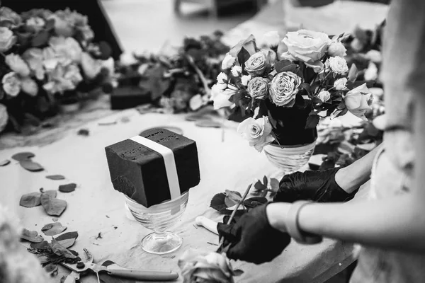 Hands of female florist arranging wedding bouquet