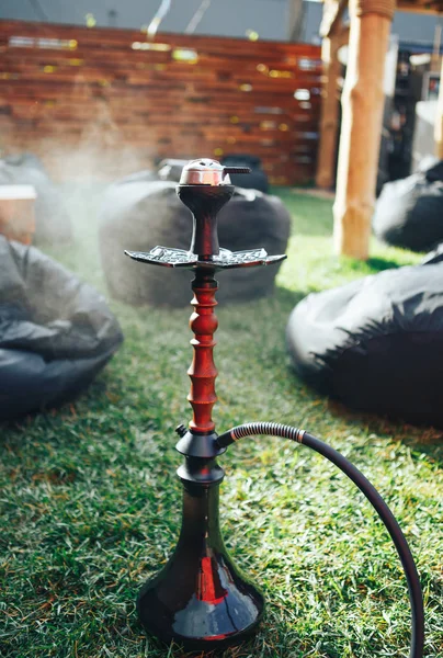 Hookah black on the street. Hookah on the grass. Background lifestyle concept . Background black pouffes — Stock Photo, Image